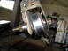 1996 Ford Bronco - Suspension component being worked on in a garage setting.