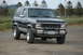 1984 Ford Bronco II - Front view of a 1984 Ford Bronco II with a bull bar and aftermarket wheels.