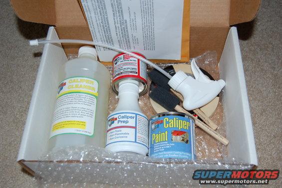 Caliper paint kit with cleaner, prep, and paint bottles, brushes, and spray nozzle inside a cardboard box