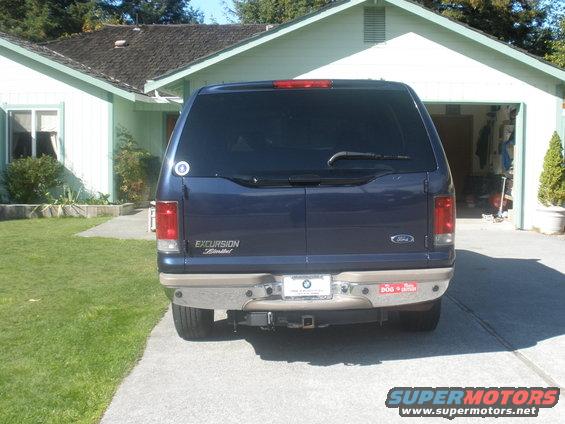 Rear view of a blue 2002 Ford Excursion Limited parked in a driveway