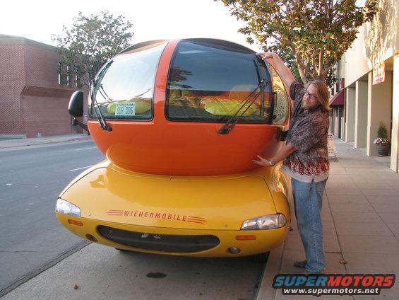 Yellow Wiener Mobile with orange top and a person posing