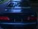 1993 Ford Taurus - The rear of a dark-colored 1993 Ford Taurus is shown, its taillights and SHO badging.