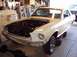1967 Ford Mustang - Front view of a 1967 Ford Mustang undergoing maintenance in a garage.