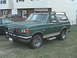 1988 Ford Bronco - This green Ford Bronco, likely a 1987 model, is equipped with a bull bar and roof rack.