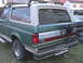 1988 Ford Bronco - Rear view of a 1988 Ford Bronco, a roof rack and a spare tire carrier mounted on the back.