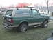 1988 Ford Bronco - This 1988 Ford Bronco is parked on a grassy lawn in front of a suburban house.
