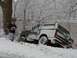 1988 Ford Bronco - A man holds a 'For Sale' sign next to a 1988 Ford Bronco partially buried in snow.