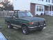 1988 Ford Bronco - This green 1988 Ford Bronco is parked on a grassy lawn in front of a house.