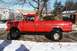 1979 Ford F-250 - This lifted red pickup truck is shown from the side on a street with snow on the ground.