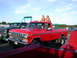 1979 Ford F-250 - Two women pose on the roof of a red 1979 Ford F-250 pickup truck parked outdoors.