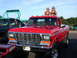 1979 Ford F-250 - This red 1979 Ford F-250 pickup truck is shown from the front with two women posing on its roof.