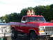 1979 Ford F-250 - Two women stand on the roof of a red 1979 Ford F-250 pickup truck parked outdoors.