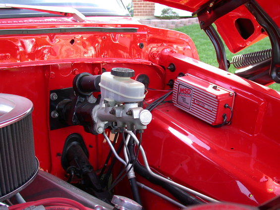 Close-up of brake master cylinder and MSD ignition box in a red engine bay