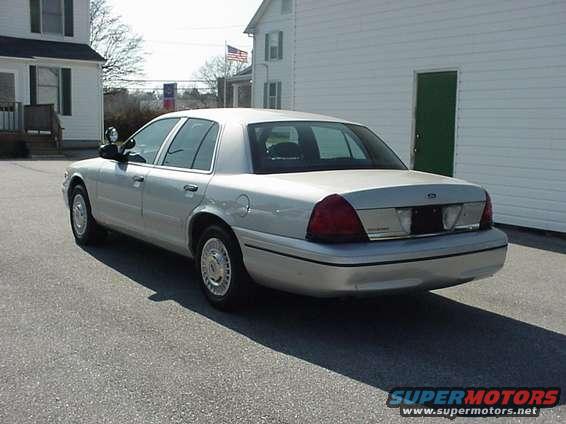 Silver sedan parked outside a building. The rear of the car is visible