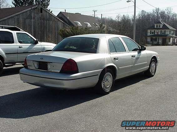 Silver 2000 Ford Crown Victoria sedan, rear 3/4 view, parked on asphalt
