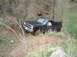 1984 Ford Bronco II - This black SUV is navigating a steep, dirt trail surrounded by dense foliage.
