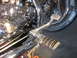 2004 Harley-Davidson Sportster Custom - Close-up of a motorcycle's engine and foot controls, showing chrome detailing and a spoked wheel.