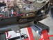 2004 Harley-Davidson Sportster Custom - Close-up view of motorcycle engine and frame components, with visible wiring and metal supports.