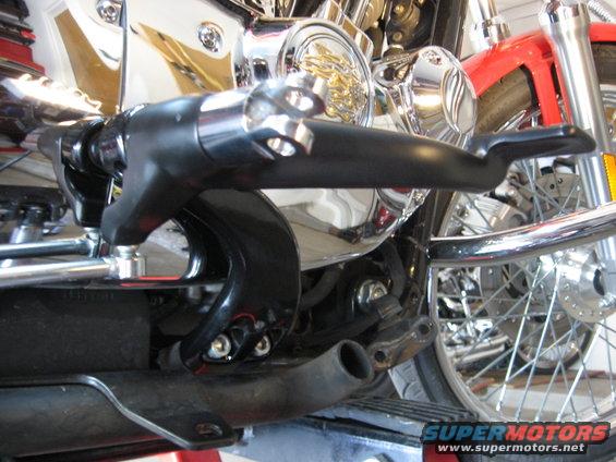 Close-up of motorcycle engine, chrome accents, and black controls