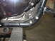 2004 Harley-Davidson Sportster Custom - Close-up view of a motorcycle's engine and frame components, showing wiring and mechanical parts.