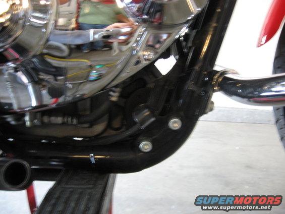 close-up of motorcycle engine and black frame with chrome accents