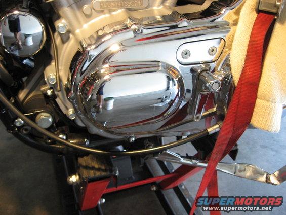 Chrome engine cover and red strap on motorcycle