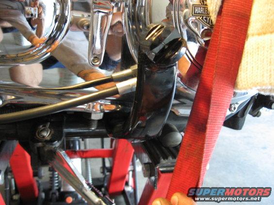 close-up of motorcycle engine with a red strap around it