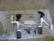 2004 Harley-Davidson Sportster Custom - A set of motorcycle foot controls, including footpegs and a brake pedal, are displayed on bubble wrap.