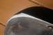 1986 Mazda RX-7 - Close-up of a car fender's underside, revealing wear and a visible bolt, with a Supermotors.net watermark.