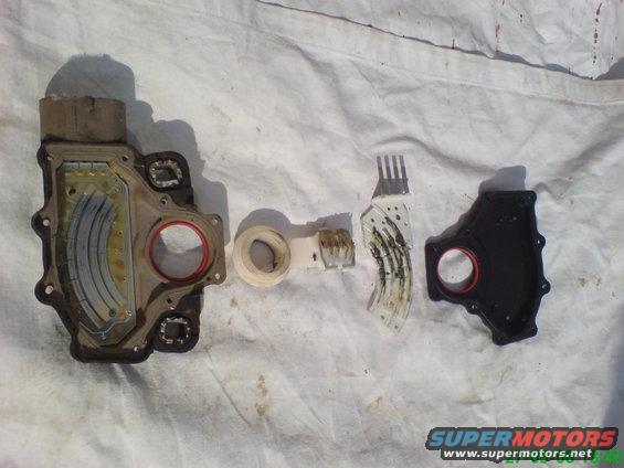 Disassembled transmission solenoid pack with electrical components and seals on a white cloth