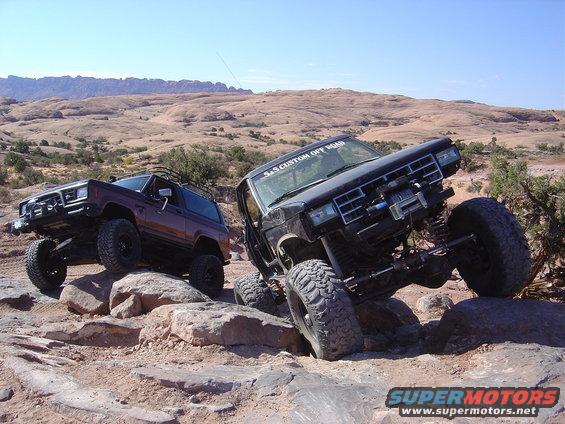 1986 Ford Bronco II and another SUV on rocky terrain