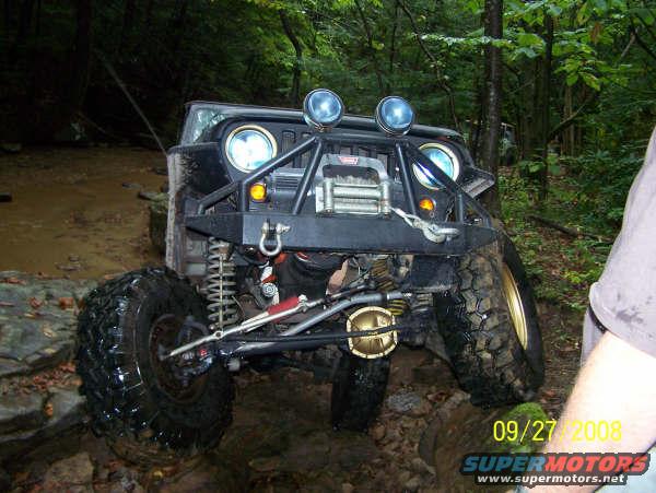 1992 Jeep Cherokee front view off-roading in mud and rocks