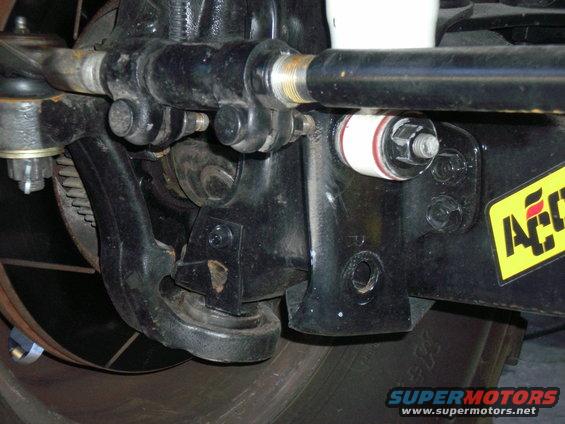 steering-stabilizer-install-008.jpg This is the original hole, below the lower front shock mount, that is drilled for the original Rancho stabilizer, but it sits too low and hits rocks etc!