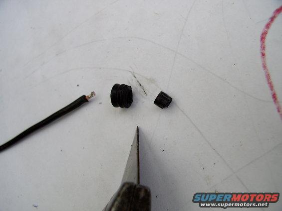 Slice the snout off the grommet, as the 10 gauge wire doesn't need the extra length.