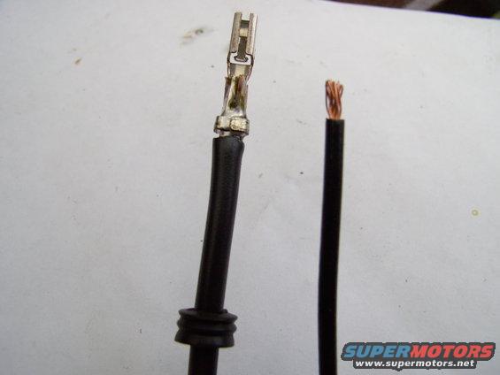 img_0067.jpg Slip the grommet over the new 10 gauge wire, crimp the outer tangs onto the wire and solder it solid.