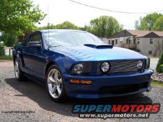 Blue 2007 Ford Mustang GT/CS with aftermarket hood scoop parked outside