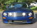 2007 Ford Mustang - Front view of a blue 2007 Ford Mustang, showing its distinctive grille and headlights.