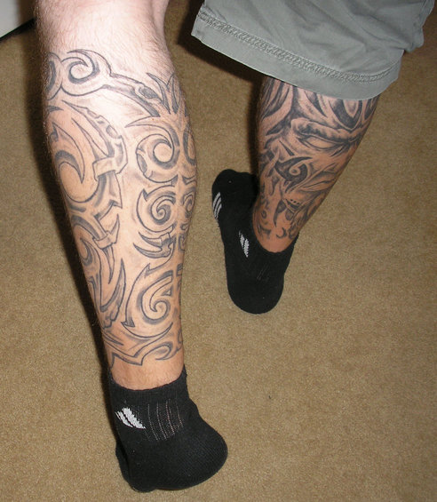 Tribal tattoos on legs with black socks