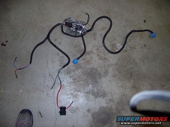 img_0087.jpg Far left note the two weatherpack type males to stick in the stock headlight socket for signal. Nearest the foot is the 40 amp Maxi fuse holder and common ground terminal. On the headlight support are the two relays with their pigtails and ground terminals.