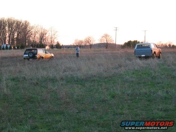 stuck1.jpg Picture of my truck stuck in the mud. My little(younger) brother is standing between my truck and his bronco on higher ground. We use his bronco basically around the farm and in the fields. We went out to have some fun in the mud... and I got stuck.
