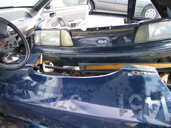 Blue Ford Mustang fender with D15 badge and faded text