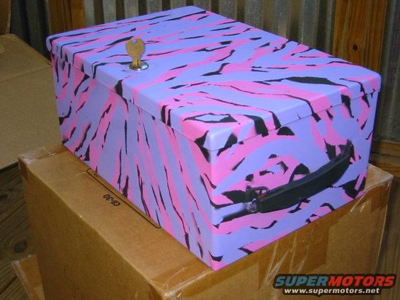 Purple, pink, and black camouflage storage box with a key in the lock