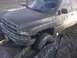 1996 Dodge 1500 - This 1996 Dodge 1500 is deeply stuck in the mud, with its front tire submerged.