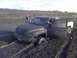 1996 Dodge 1500 - Mud-covered 1996 Dodge 1500 stuck in a muddy field with the driver's door open.