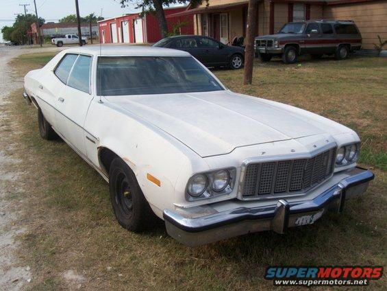right-front.jpg Right front view of the car, not much to say here other than it's another good place to see the grille wear, sticker residue, and the license plate thingy.  Oh yeah, and my house, my Suburban, and my wife's rental Cobalt.  And kids toys.  And probably some dogs if you look close.
