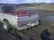 1996 Dodge 1500 - Muddy 1996 Dodge 1500 stuck in a muddy field, rear view showing the tailgate and tires.