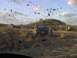 1996 Dodge 1500 - Several trucks are stuck in a muddy area, with people observing the situation. Mud is flying through the air.