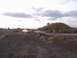 1996 Dodge 1500 - Multiple vehicles and people gathered on a dirt road with a large hill in the background.