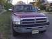 1996 Dodge 1500 - This Dodge Ram pickup truck has a two-tone paint job and a prominent chrome grille.