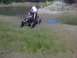 1996 Dodge 1500 - Riding mower stuck in mud near a body of water with a person on it.
